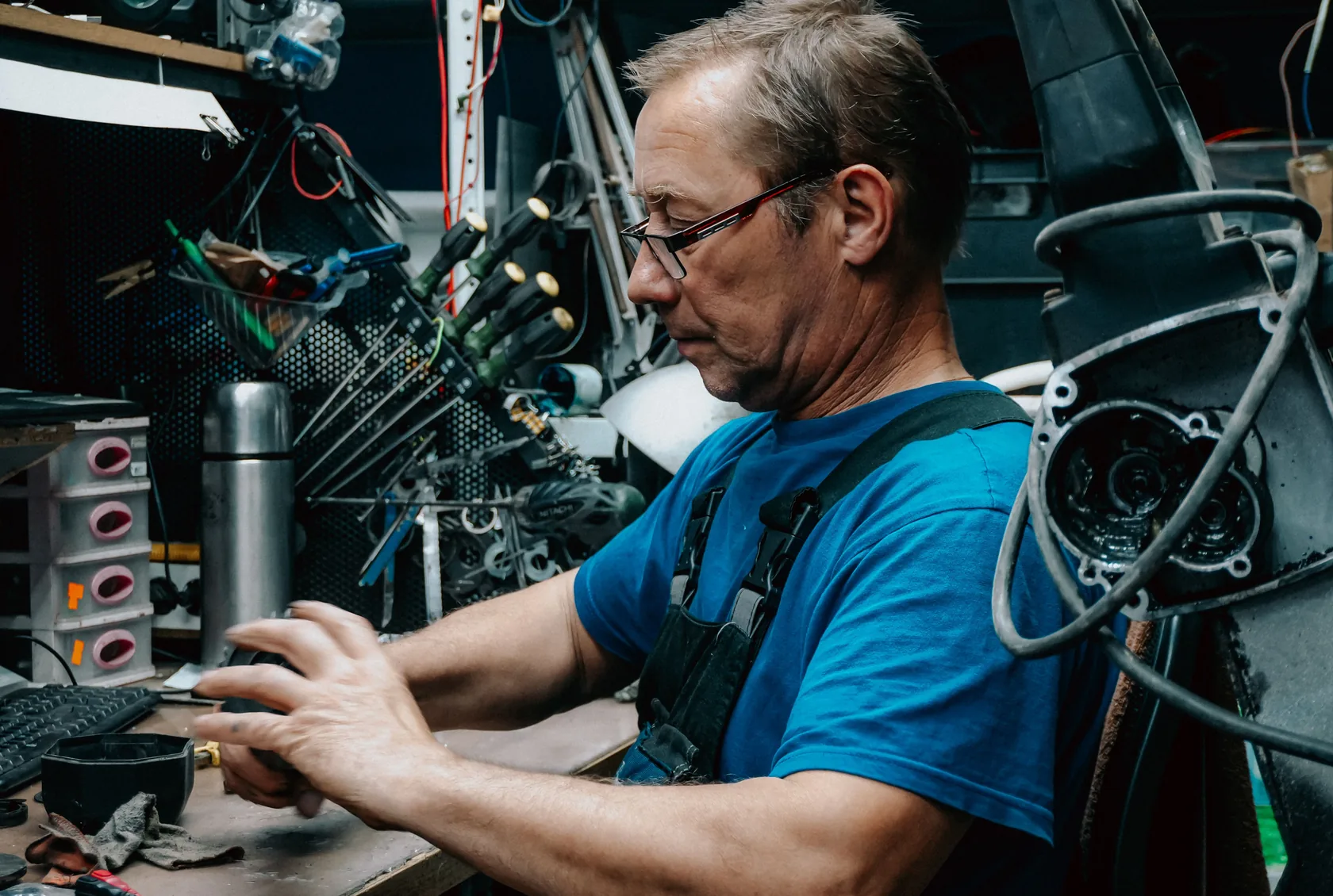 A bicycle mechanic working at his bench in his own workshop